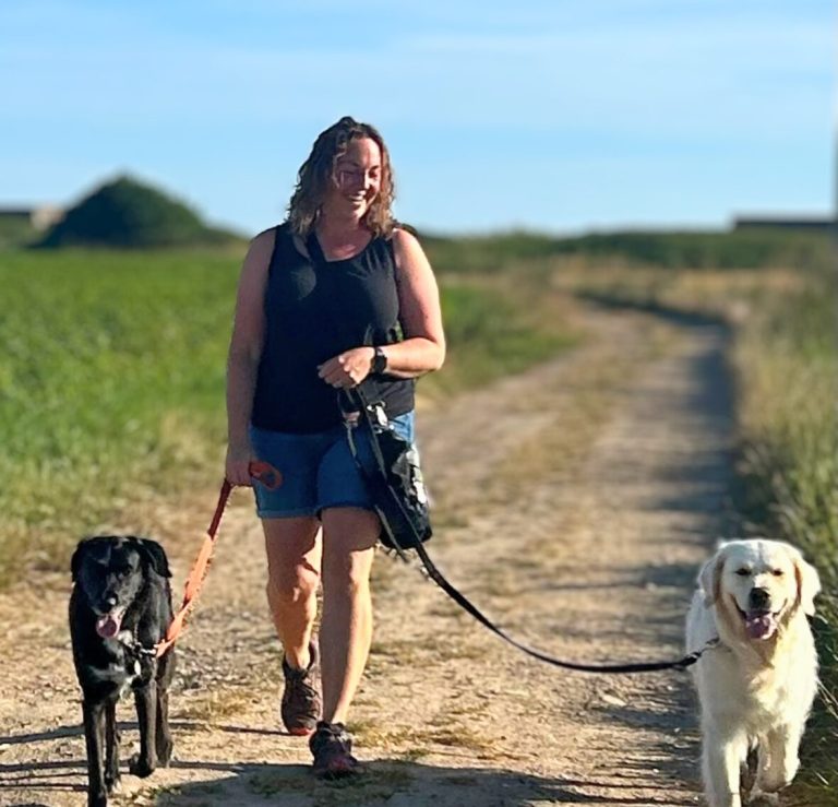 realxed lead walking women walking two dogs down a lane
